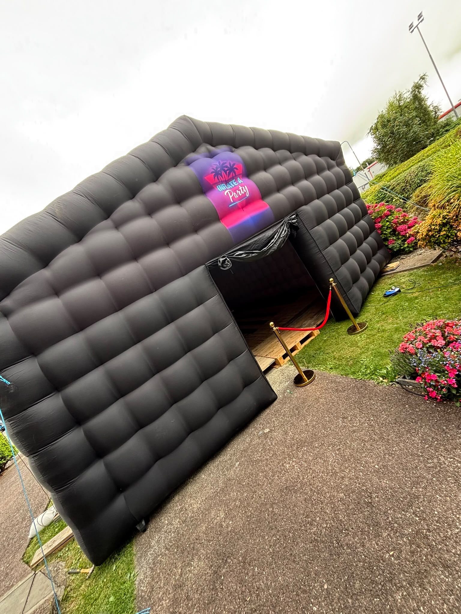 Angled view of the branded inflatable nightclub in a garden